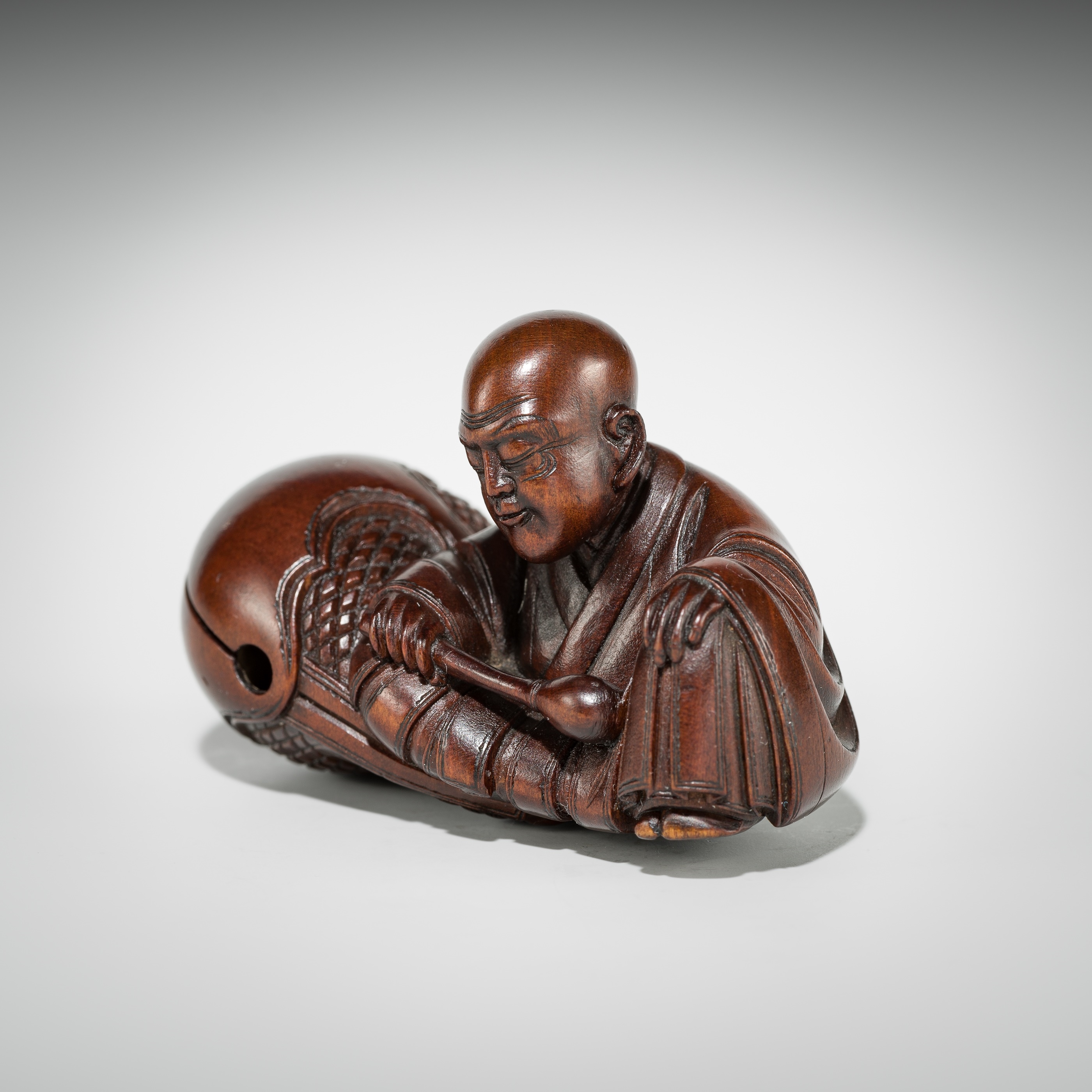Artwork by Shûmin, SHUMIN: A FINE WOOD NETSUKE OF A MONK WITH MOKUGYO, Made of wood