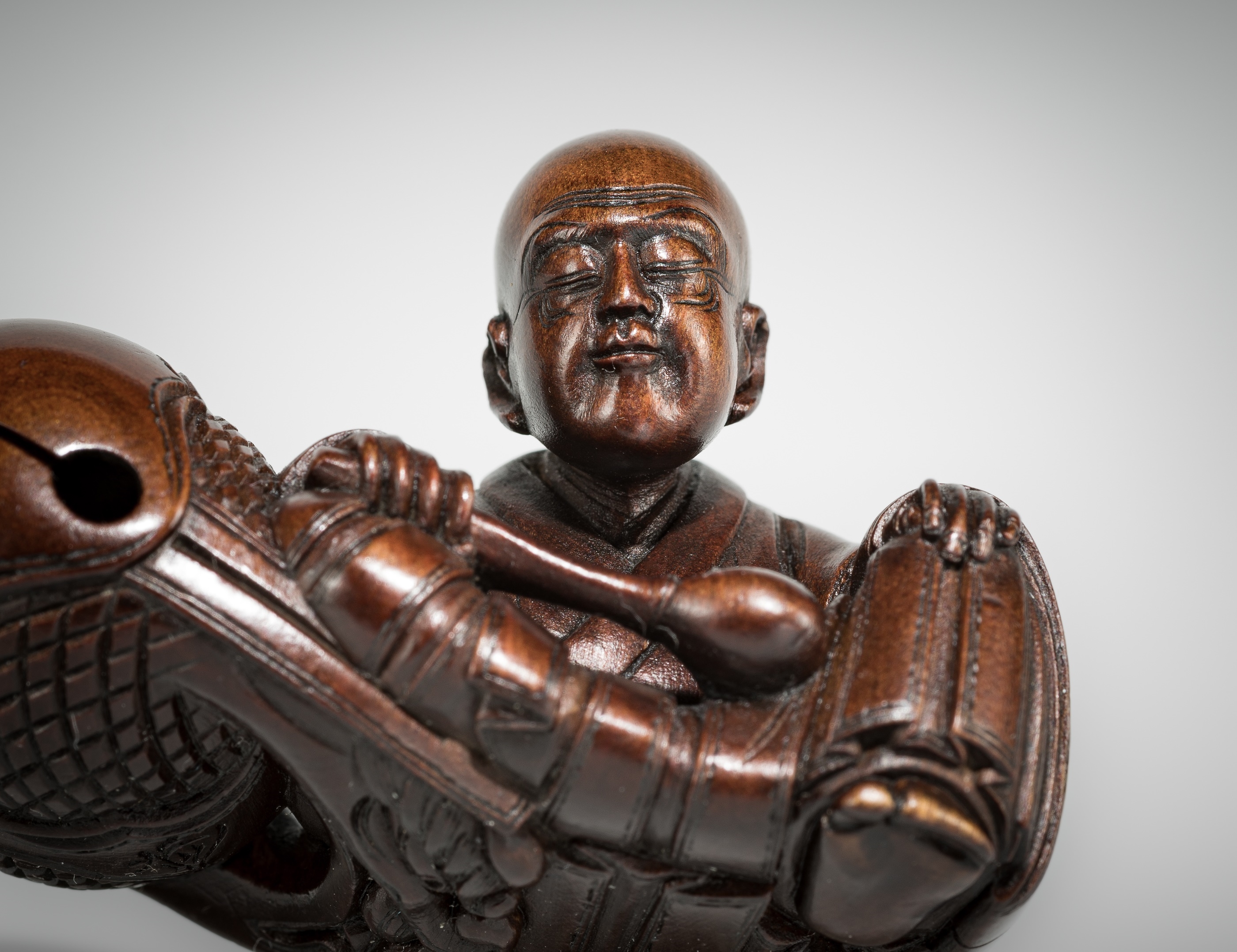 Artwork by Shûmin, SHUMIN: A FINE WOOD NETSUKE OF A MONK WITH MOKUGYO, Made of wood