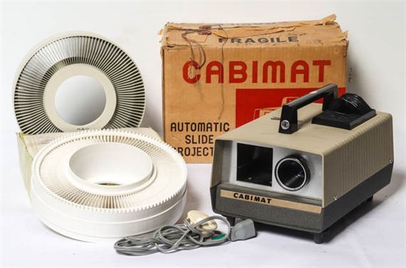 A vintage Cabimat automatic slide projector with manual in original box by MANUAL