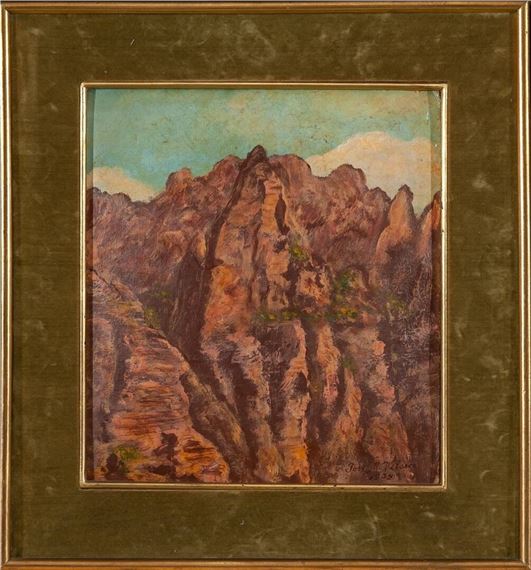 A framed landscape painting of a rugged canyon with layered rock formations under a pale sky.