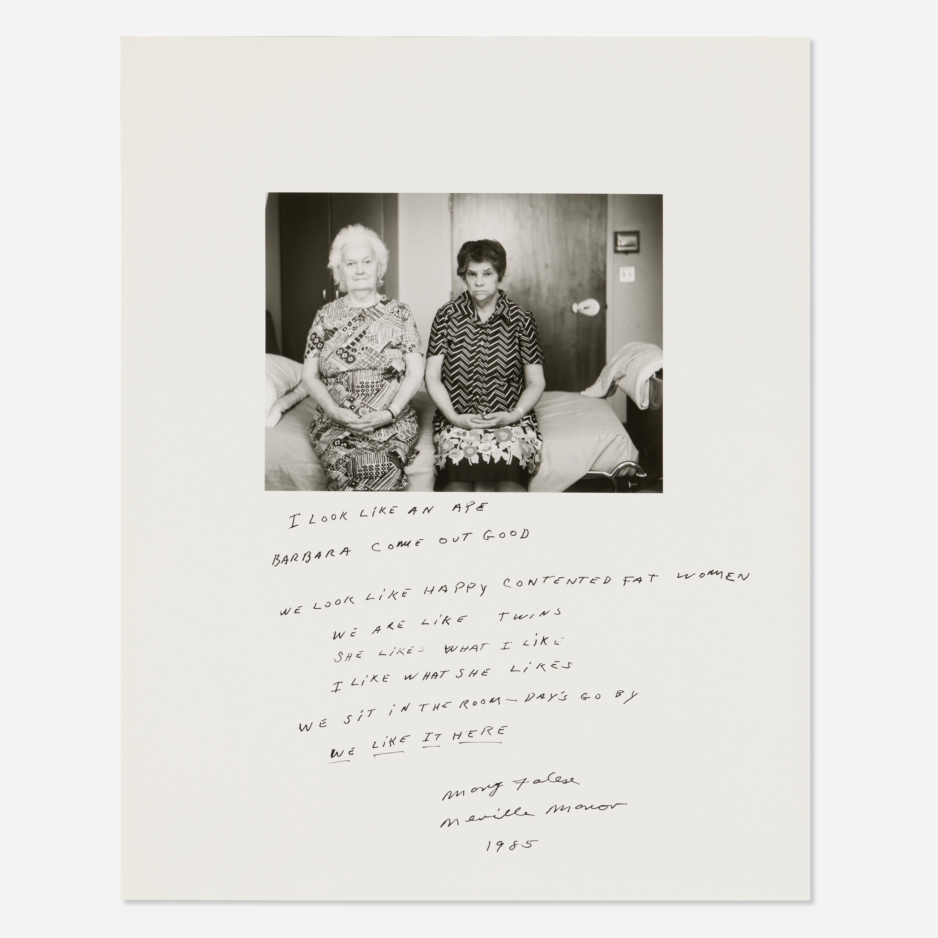 A black-and-white photograph of two seated women with handwritten text below.