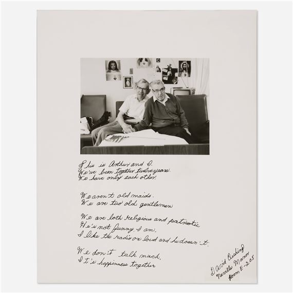 A black-and-white photograph of two elderly figures seated together, accompanied by handwritten text.