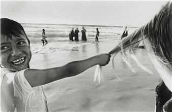 Palestinian boy playing with a horsetail at the beach of Gaza City - Kai Wiedenhöfer
