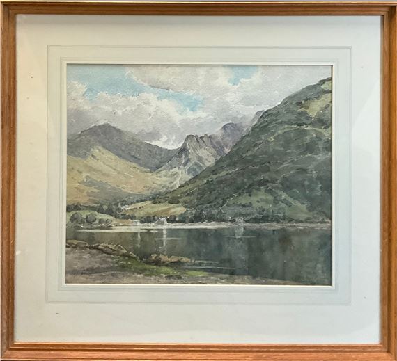 A framed watercolor landscape of a calm lake nestled between rolling hills and distant mountains under a cloudy sky.
