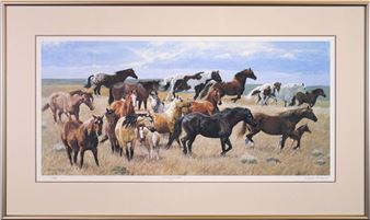 A framed print of a herd of wild horses galloping across a dry grassland under a cloudy sky.