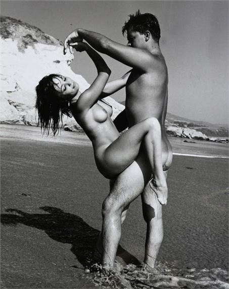 Nude woman and man by the water by Andre de Dienes, circa 1960