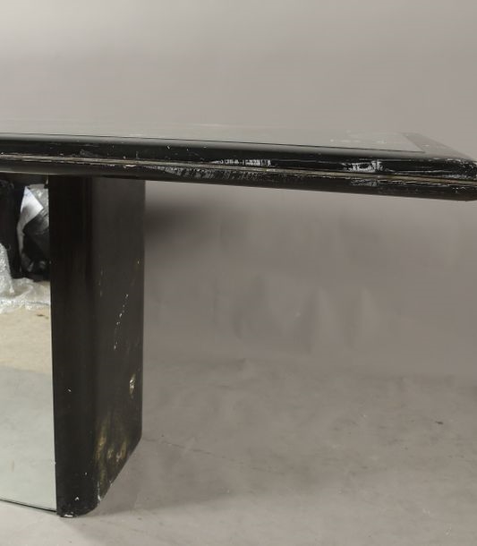Artwork by Claude Saint-Pierre, RECTANGULAR dining-room table, circa 1980, in black melamine-coated wood, resting on a high pedestal with rounded uprights, top and base adorned with mirrors, Made of black melamine-coated wood