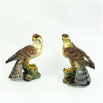 A PAIR OF CERAMIC FALCONS - Anne Gordon