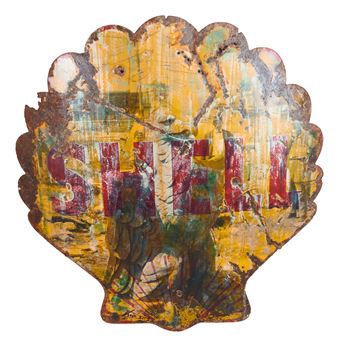 A weathered, shell-shaped sign featuring a vintage gas station logo and abstract paint splatters.