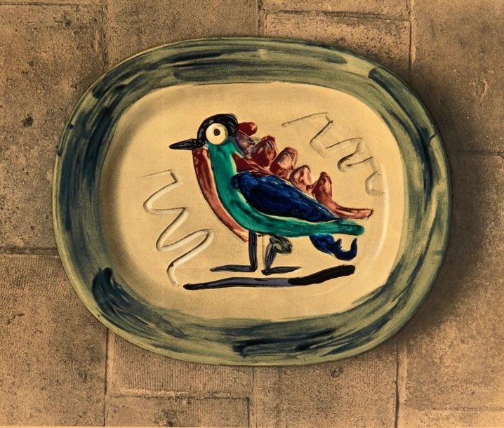 A poster advertising a ceramic plate with a bird on it.