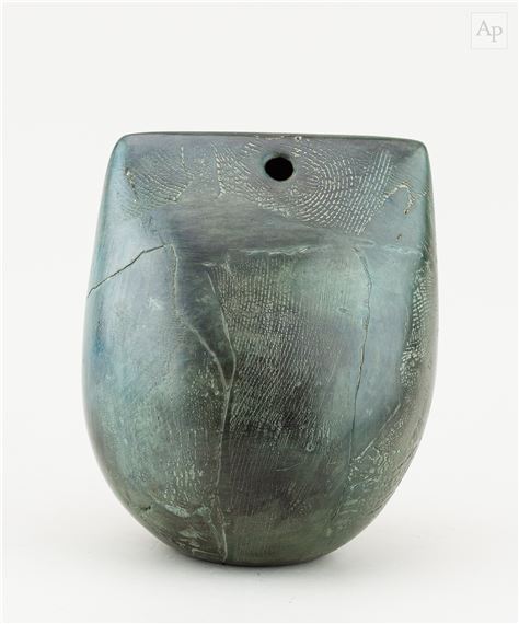a pierced raku bow with fractured smoky dark green surface by Peter Hayes