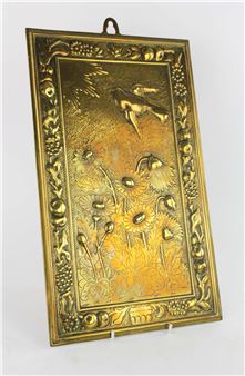 MANNER OF BRUCE TALBERT, a rectangular brass plaque, decorated with a bird flying towards the sun, above lotus plants, in a border of fruit and flowers, 38 x 23cm - Bruce Talbert