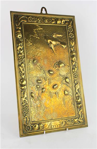 MANNER OF BRUCE TALBERT, a rectangular brass plaque, decorated with a bird flying towards the sun, above lotus plants, in a border of fruit and flowers, 38 x 23cm - Bruce Talbert
