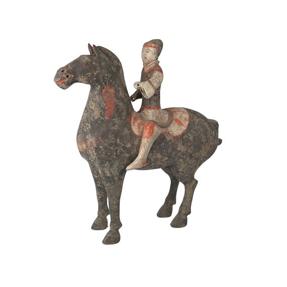 A CHINESE TERRA COTTA HORSEMAN FIGURINE by Chinese School