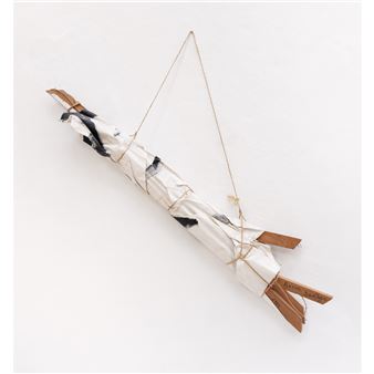 A suspended, wrapped bundle resembling a stylized bird or creature.