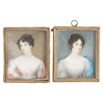 A pair of small, framed portraits depicting two women in period dress.