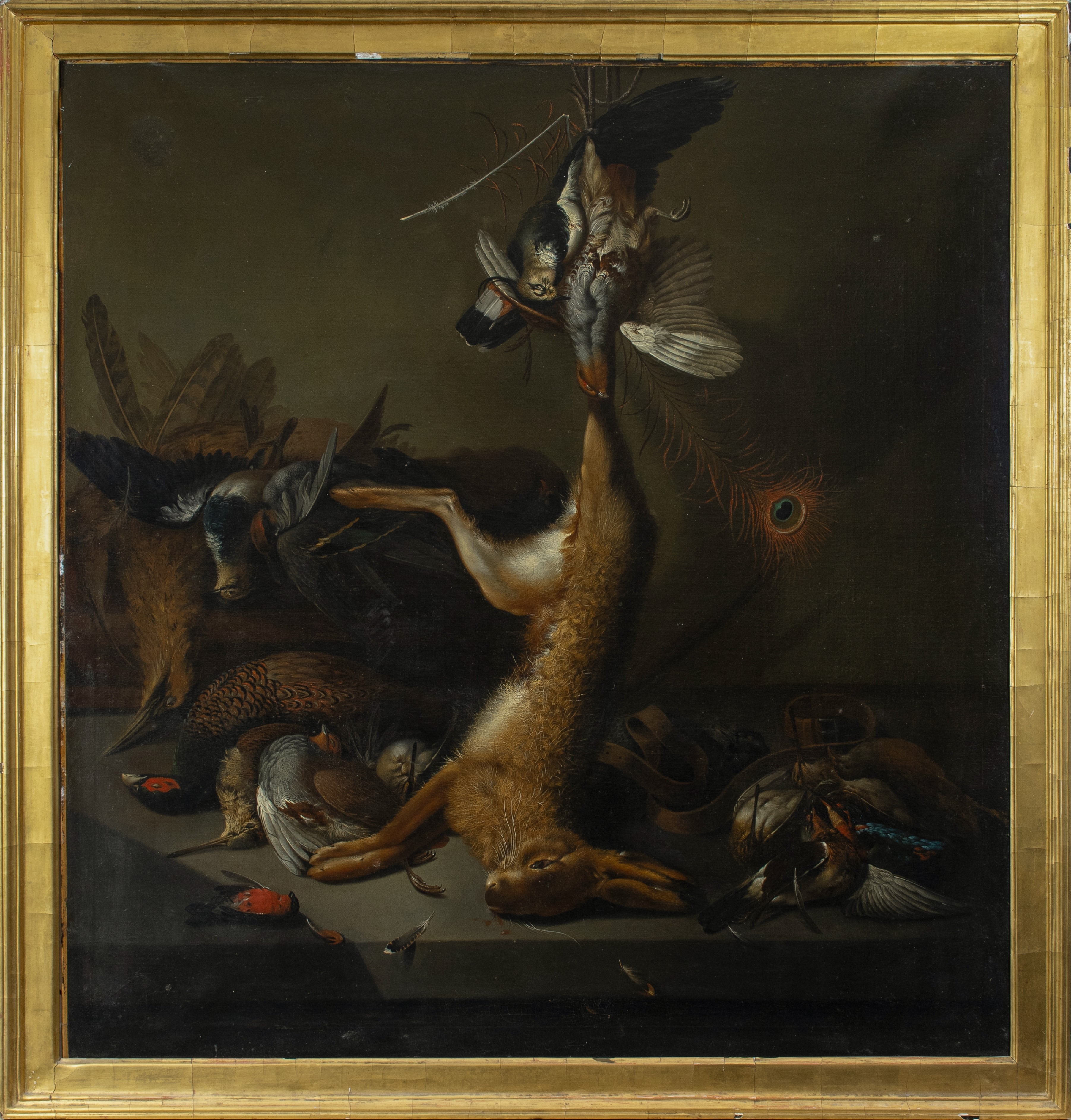 A still life arrangement of dead game birds and a hare posed dramatically on a dark surface.