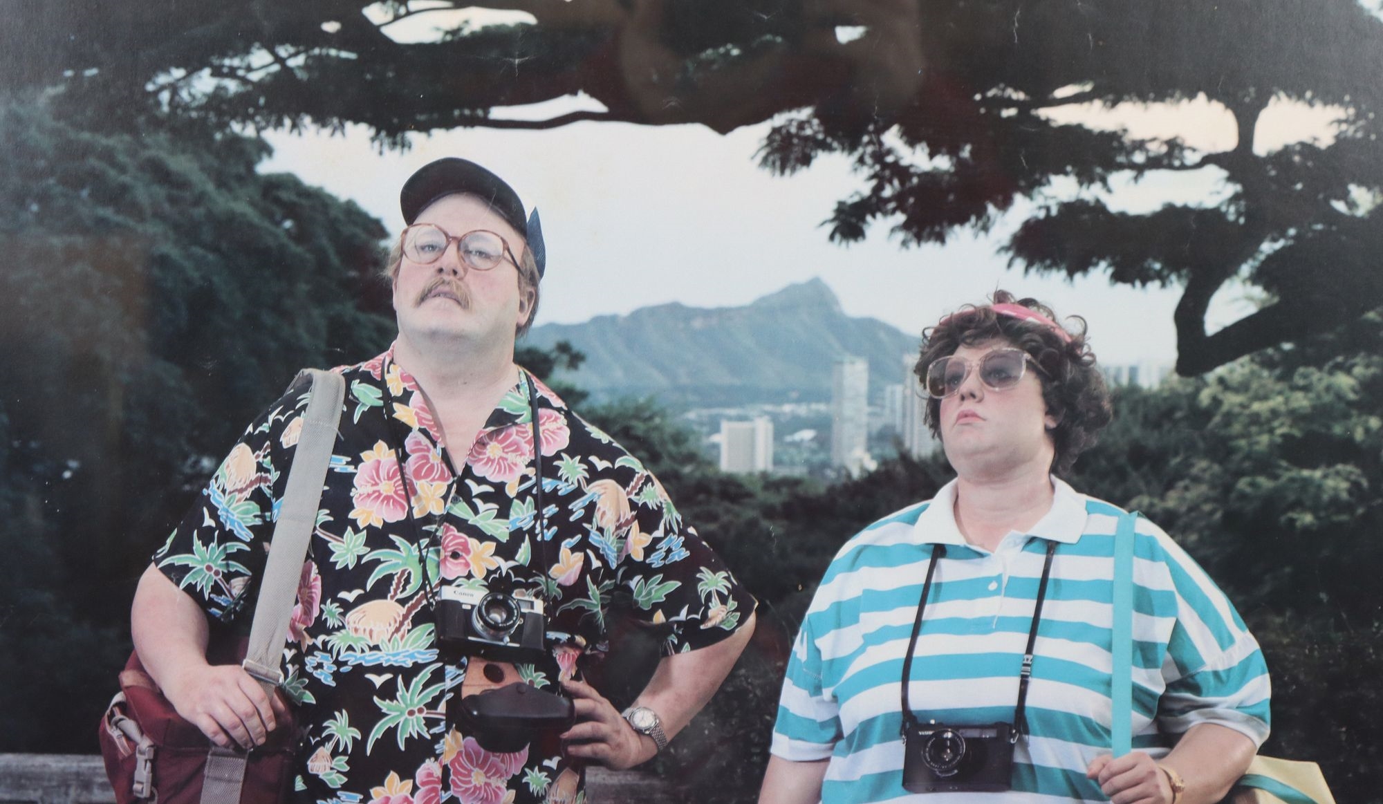 Artwork by Duane Hanson, Two of the artist's stunningly lifelike figures as bored tourists in a tropical paradise, Made of Poster