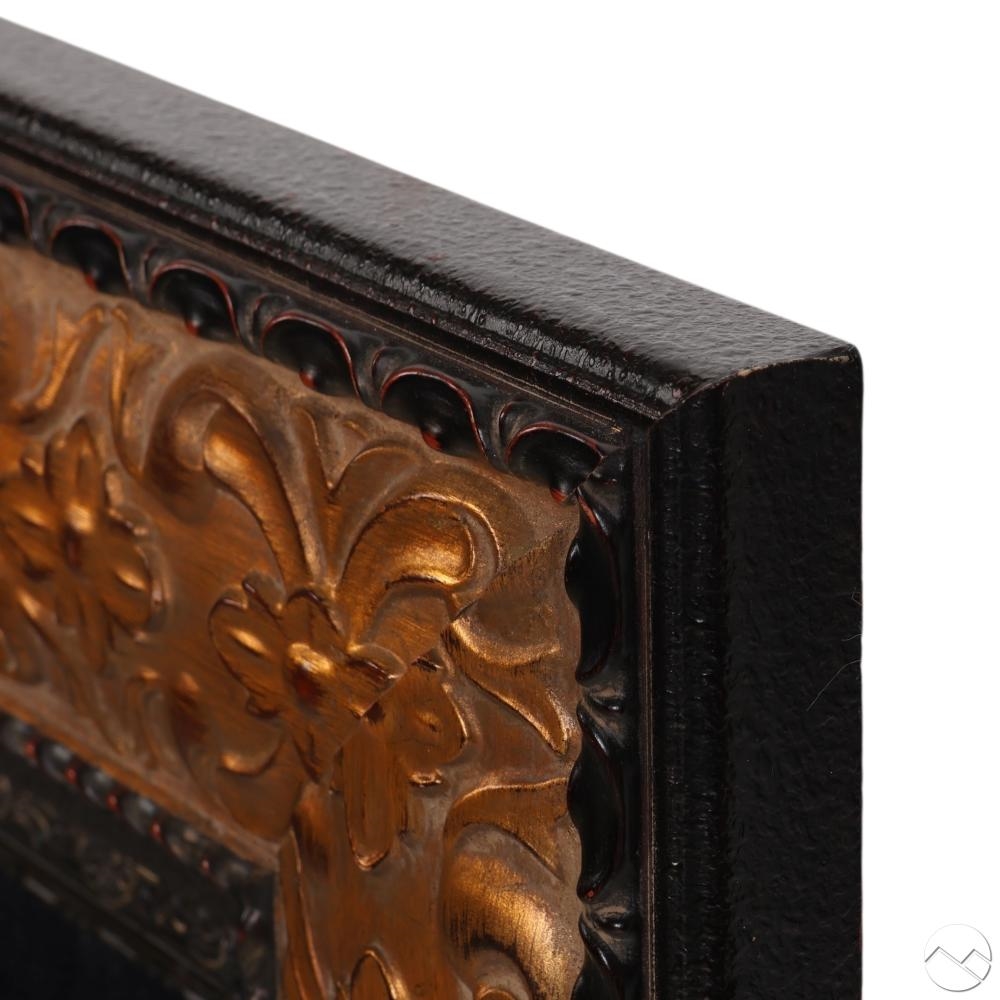 A masked figure in a richly ornate frame adorned with floral and geometric patterns.