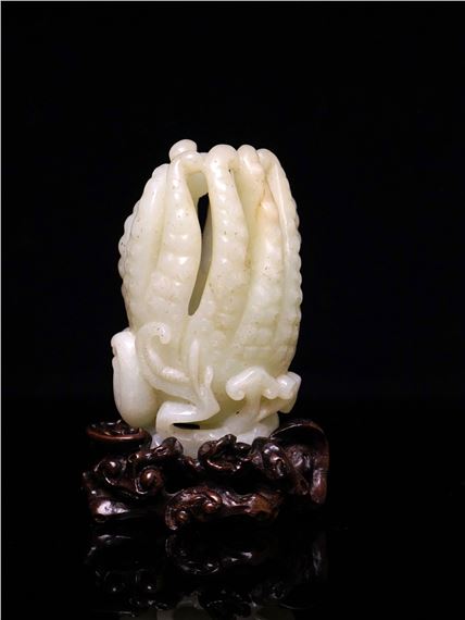 A Chinese Carved White Jade Fingered Citron with Wood Stand by Chinese School
