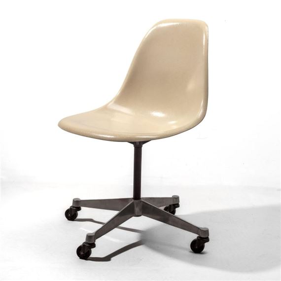 A beige molded chair with a dark metal base and casters.