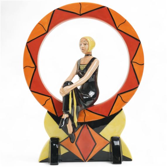 Limited edition figure, depicting an art deco lady seated in a geometric orange and red ring