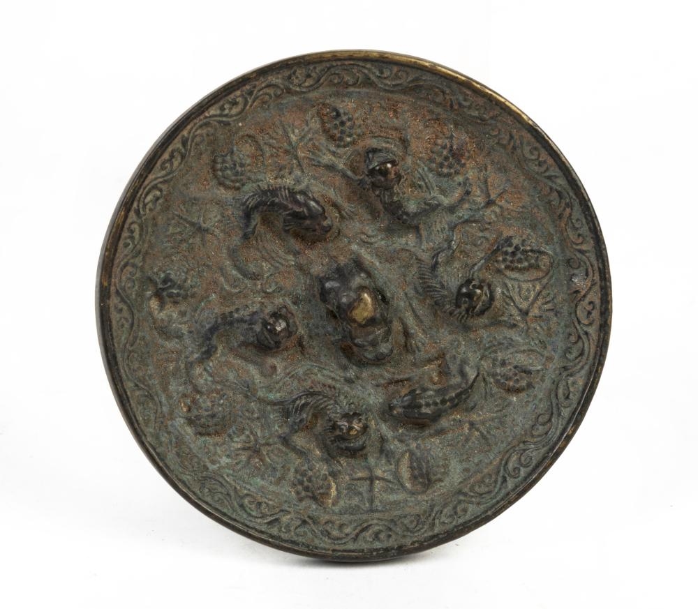Artwork by Chinese School, A Chinese bronze 'lion and grapevine' mirror, Made of Bronze