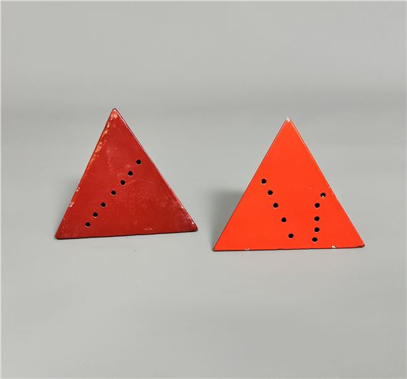 Two pyramids in red painted metal with scattered circles by Lucio Fontana, 20th century
