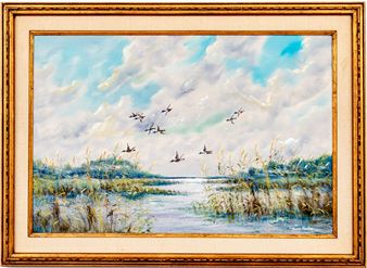 A framed landscape painting of a marshy river with flying birds against a cloudy sky.