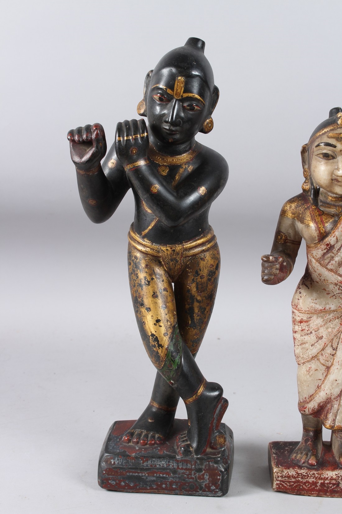 Artwork by Indian School, 19th Century, A LARGE AND FINELY CARVED EARLY 19TH CENTURY INDIAN PAINTED AND GILDED STONE FIGURES OF KRISHNA, Made of Painted And Gilded Stone