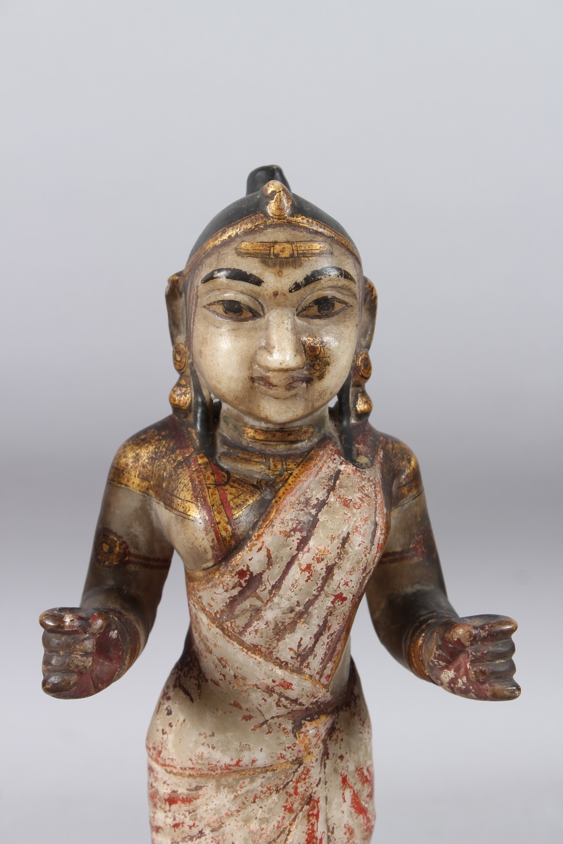 Artwork by Indian School, 19th Century, A LARGE AND FINELY CARVED EARLY 19TH CENTURY INDIAN PAINTED AND GILDED STONE FIGURES OF KRISHNA, Made of Painted And Gilded Stone