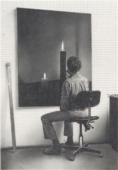 A person sits before a large painting of two lit candles, creating a scene of quiet contemplation.