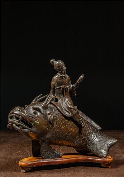 A RARE CHINESE BRONZES FIGURE OF AN IMMORTAL RIDING A MTHICAL FISH-DRAGON by Chinese School