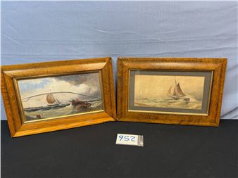 A pair of framed maritime paintings depicting sailing vessels on choppy seas.