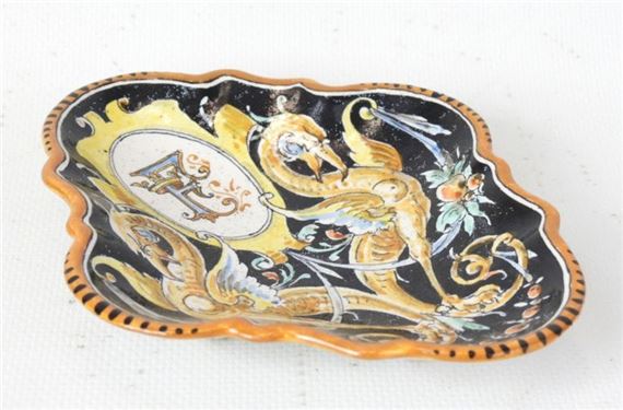 Earthenware pocket dish decorated with chimeric animals surrounding an "F by Ulysse Besnard