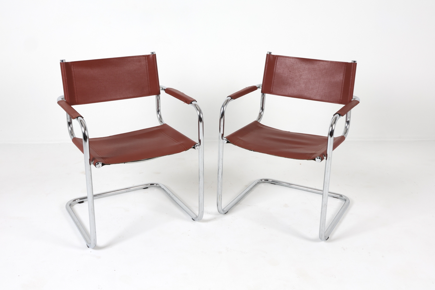 Artwork by Mart Stam, Cantilever dining chairs, Made of Chrome steel with brown leather upholstery