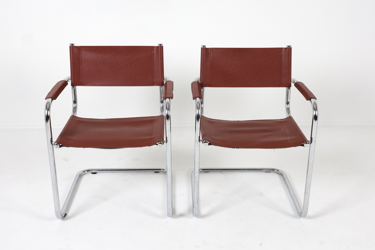 Artwork by Mart Stam, Cantilever dining chairs, Made of Chrome steel with brown leather upholstery