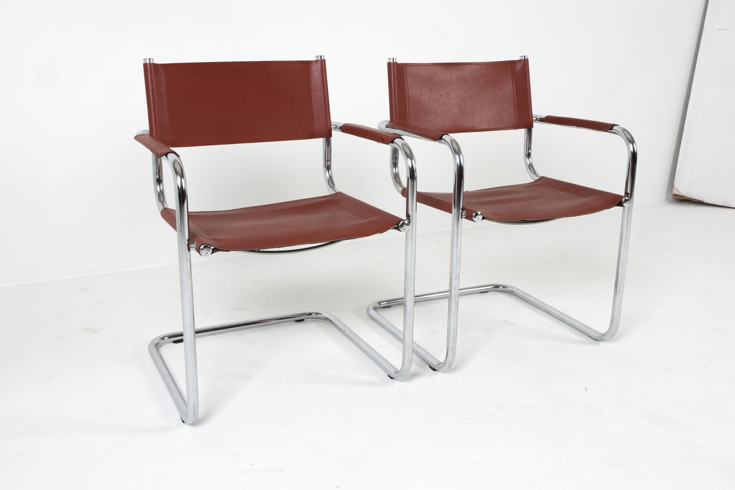 Artwork by Mart Stam, Cantilever dining chairs, Made of Chrome steel with brown leather upholstery