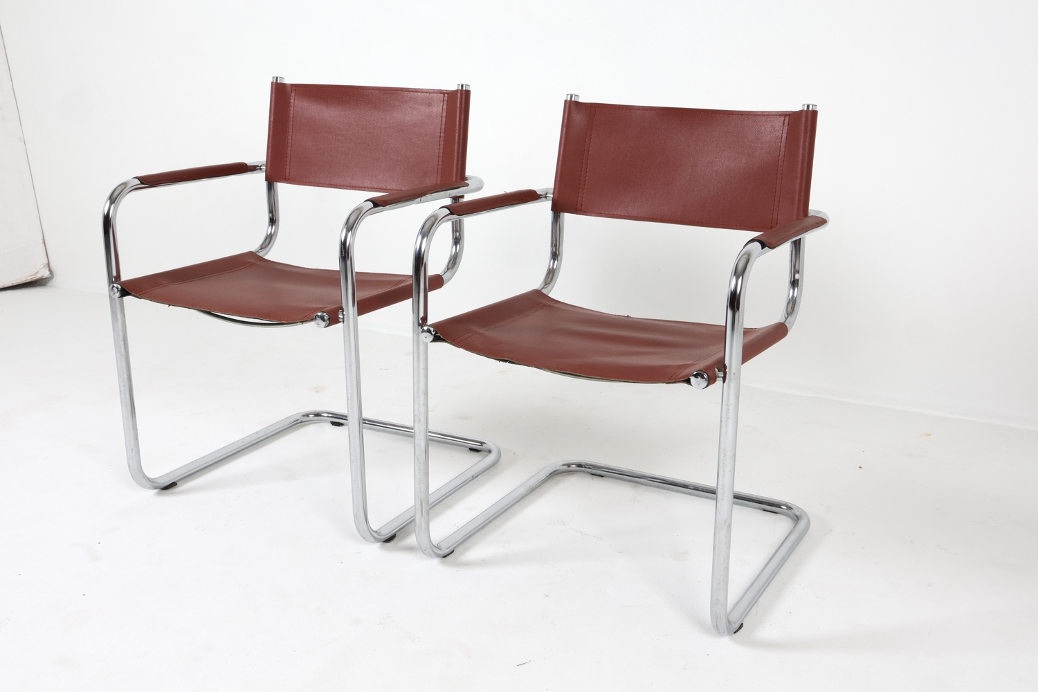 Artwork by Mart Stam, Cantilever dining chairs, Made of Chrome steel with brown leather upholstery