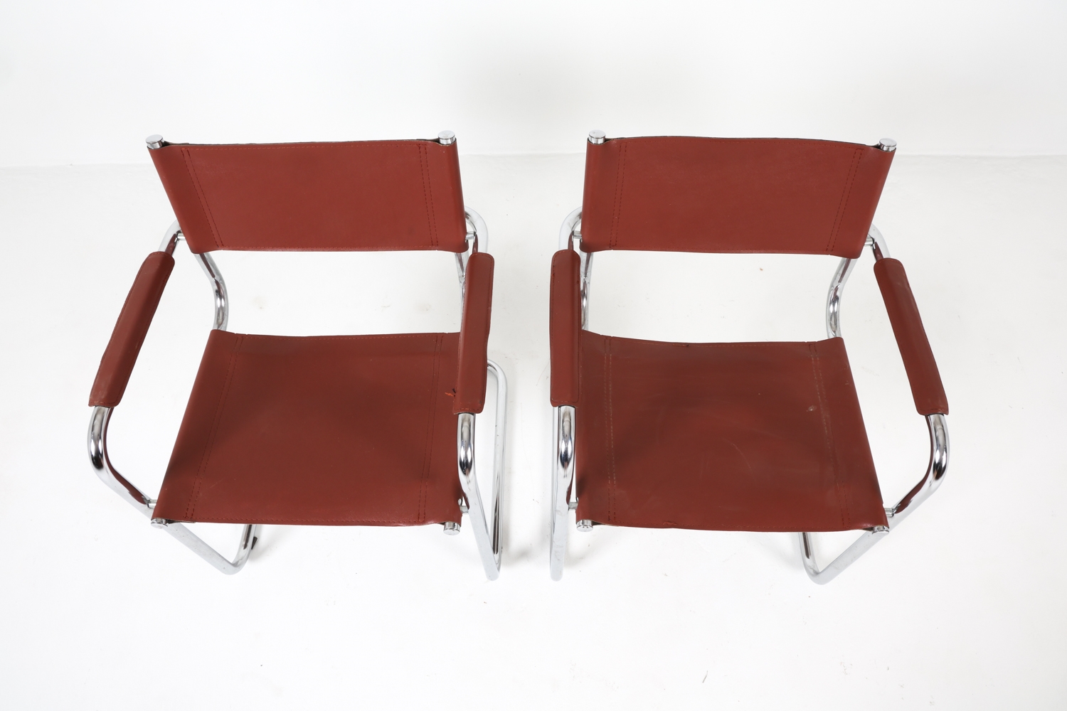 Artwork by Mart Stam, Cantilever dining chairs, Made of Chrome steel with brown leather upholstery