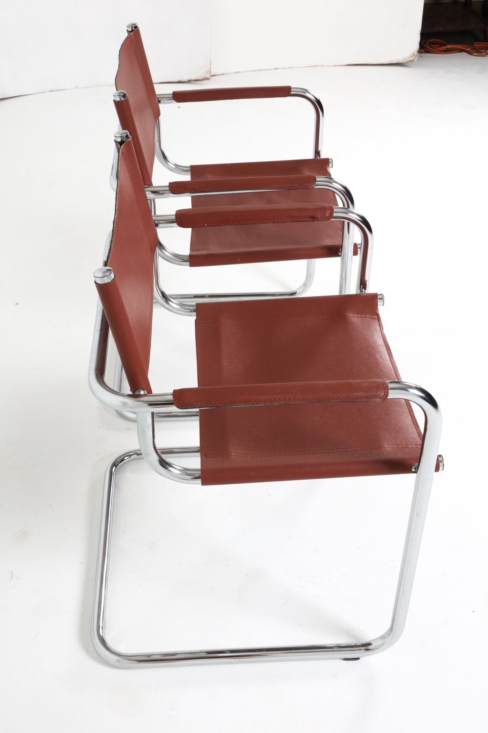 Artwork by Mart Stam, Cantilever dining chairs, Made of Chrome steel with brown leather upholstery