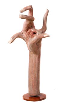 A wooden sculpture of a hand in a dramatic gesture.