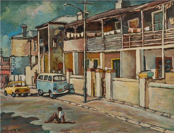 A street scene featuring a person sitting on the road, two vintage cars parked along a row of colorful buildings.
