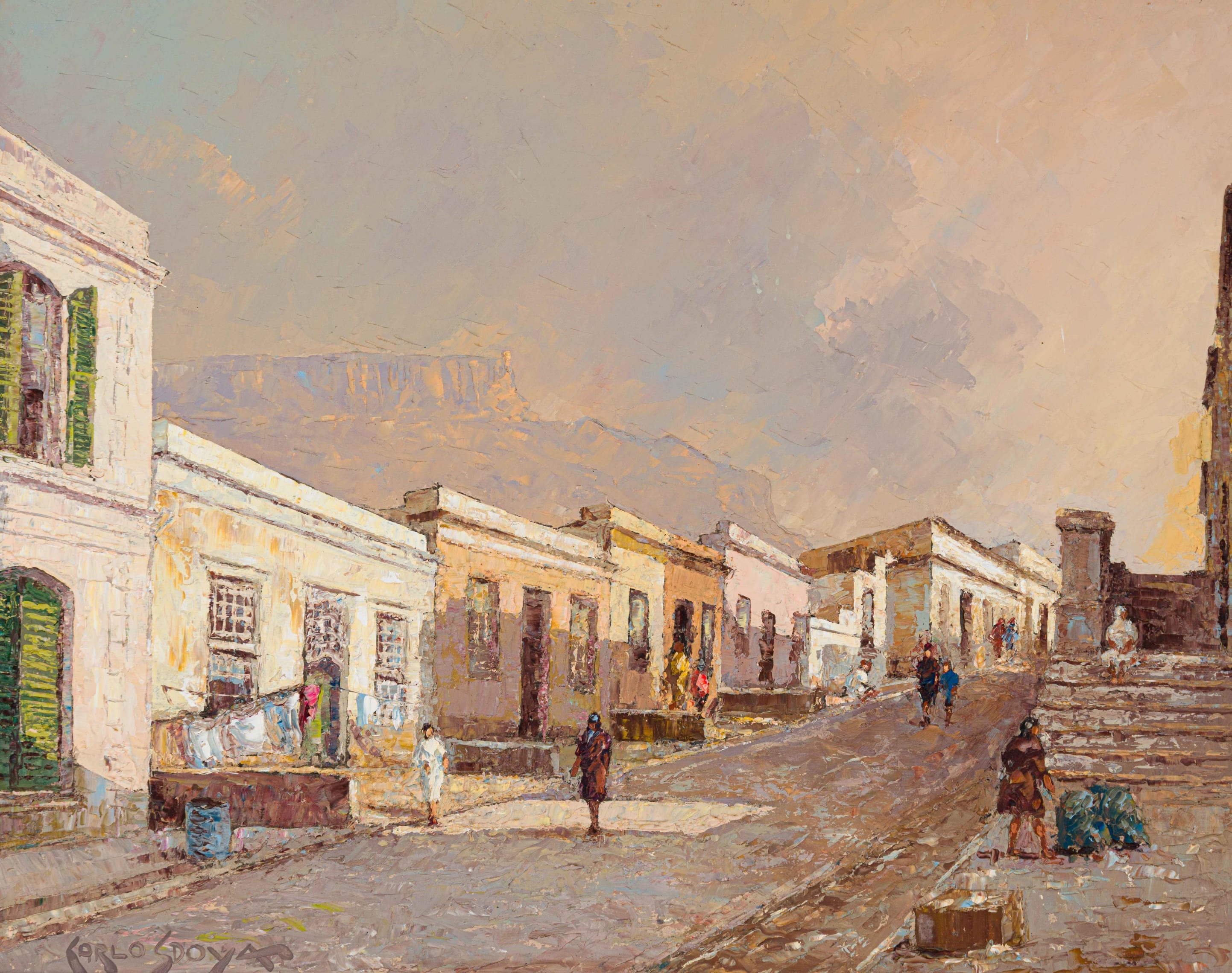 A sun-drenched street scene with colonial-style buildings and distant mountains.