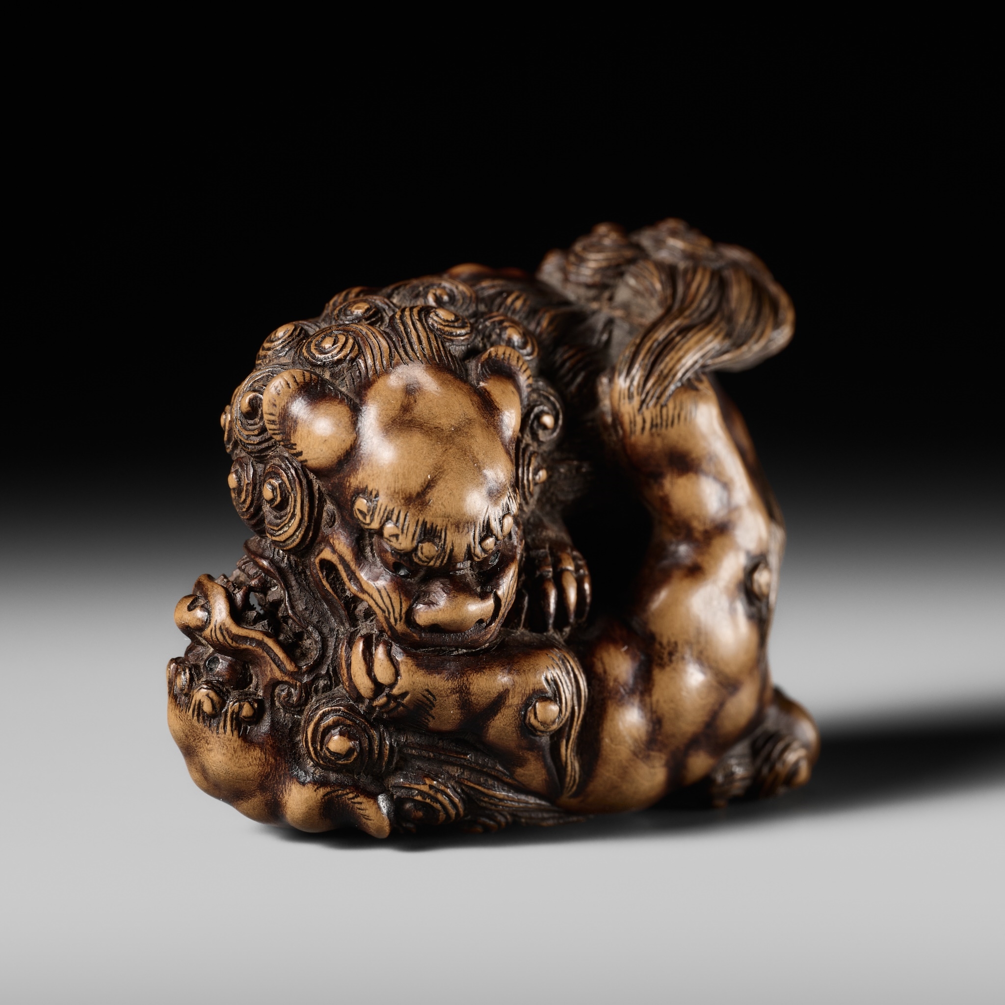 Artwork by Tomoyuki Tanaka, A LARGE AND POWERFUL WOOD NETSUKE OF TWO SHISHI, Made of Wood
