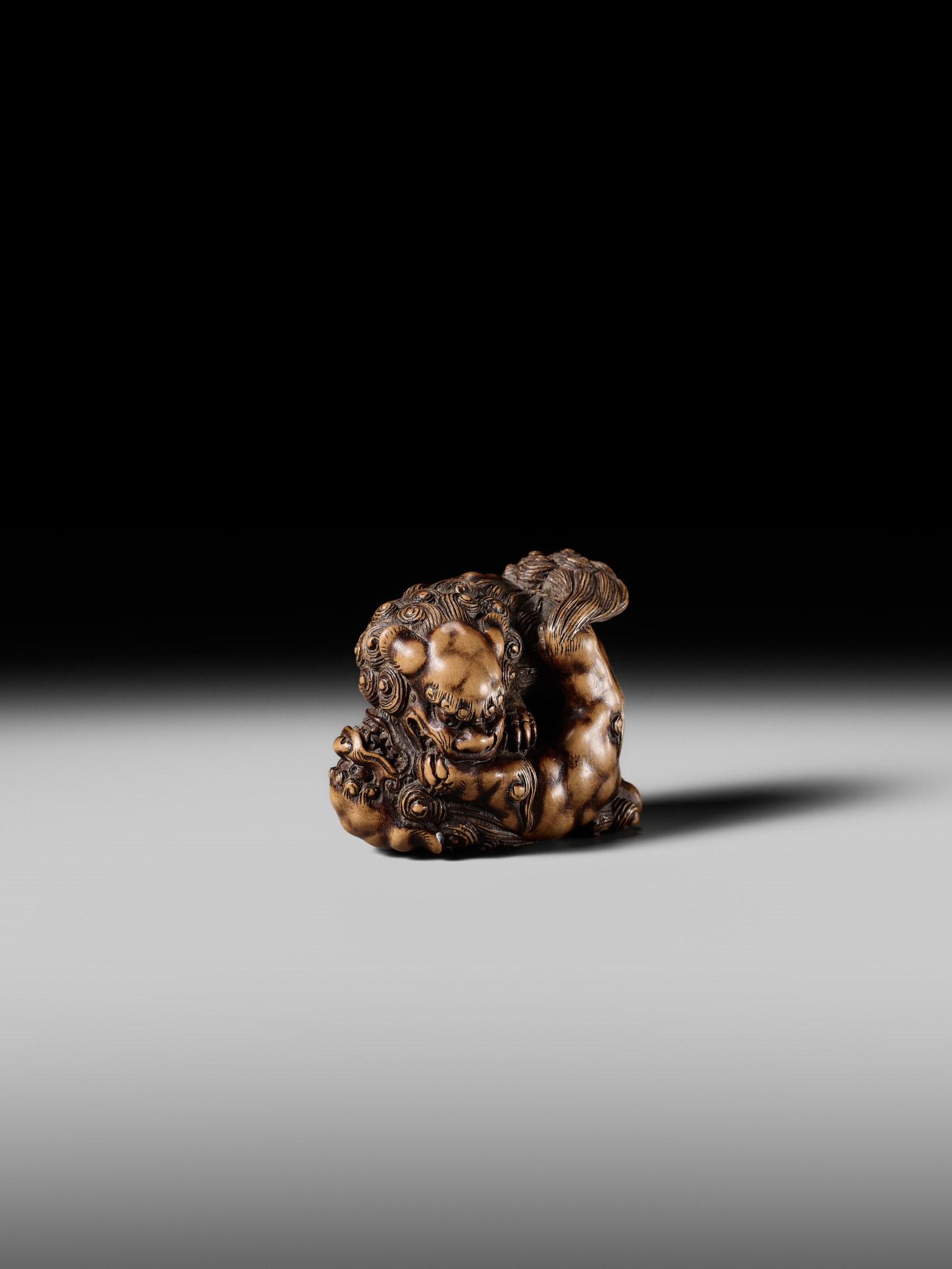 Artwork by Tomoyuki Tanaka, A LARGE AND POWERFUL WOOD NETSUKE OF TWO SHISHI, Made of Wood