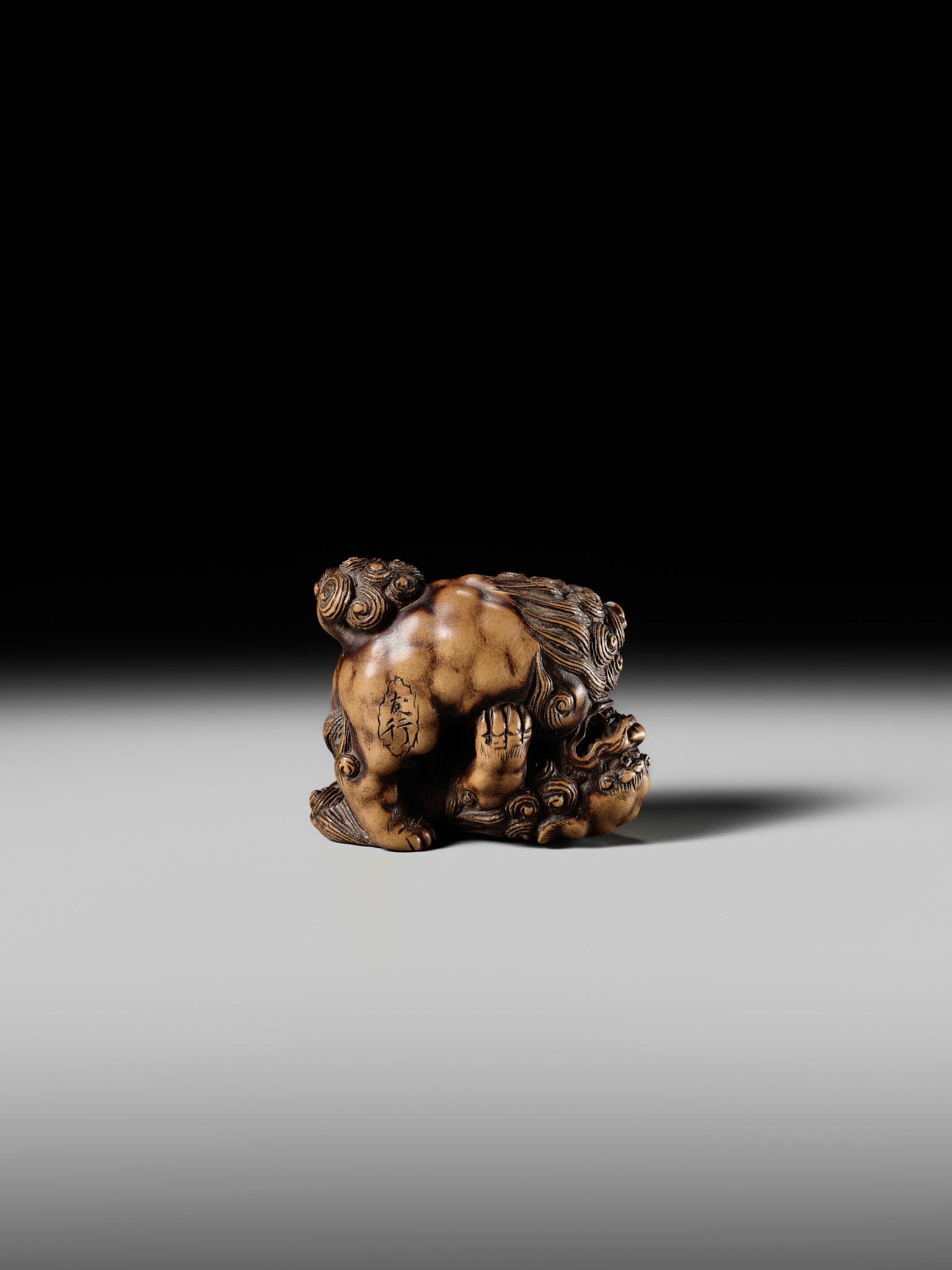 Artwork by Tomoyuki Tanaka, A LARGE AND POWERFUL WOOD NETSUKE OF TWO SHISHI, Made of Wood