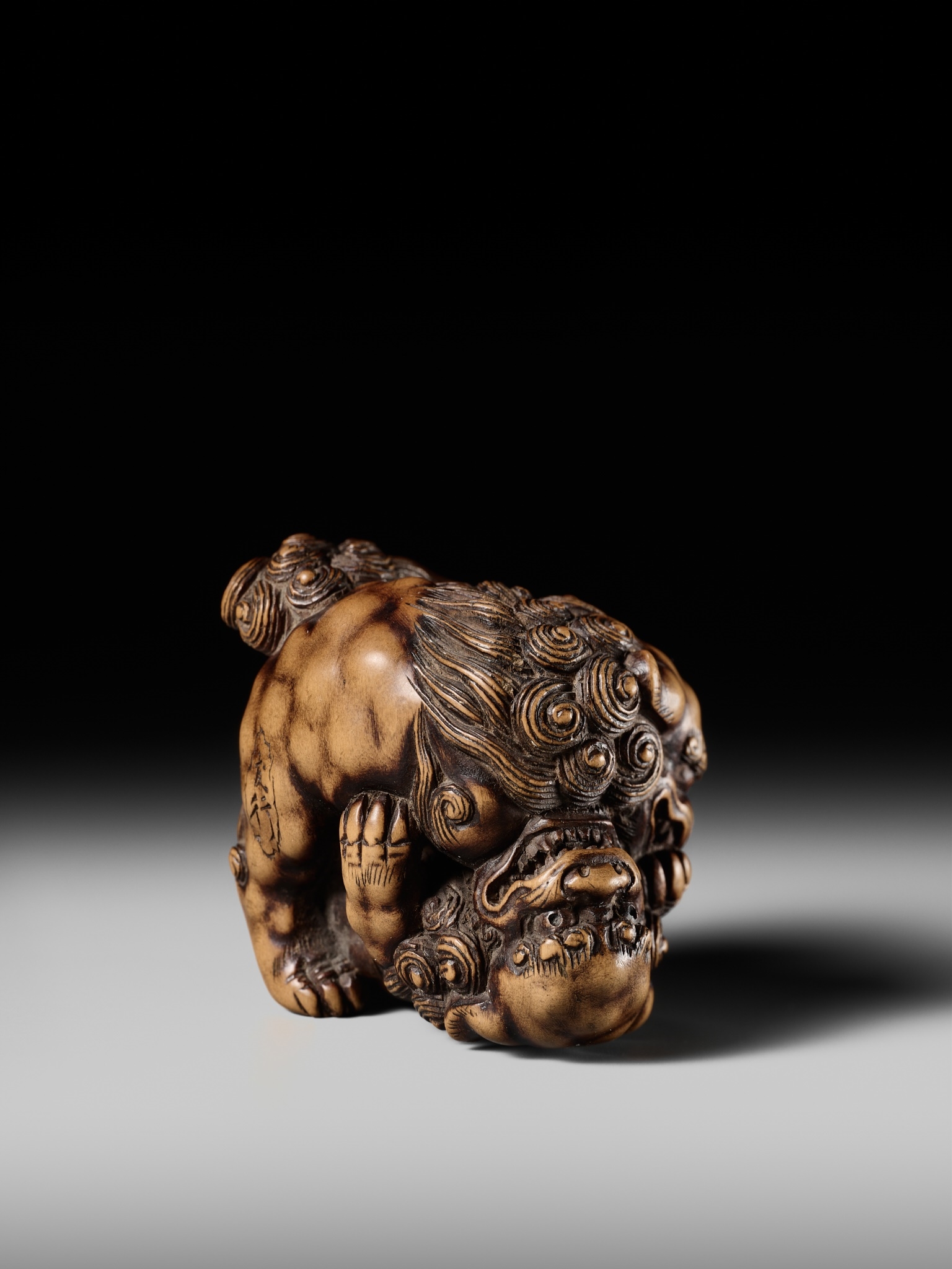 Artwork by Tomoyuki Tanaka, A LARGE AND POWERFUL WOOD NETSUKE OF TWO SHISHI, Made of Wood