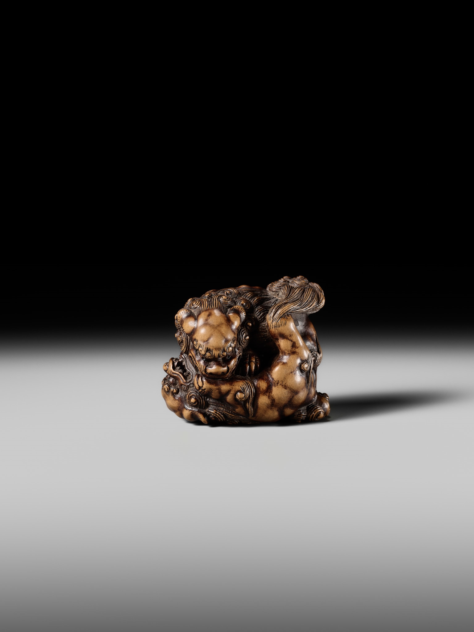 Artwork by Tomoyuki Tanaka, A LARGE AND POWERFUL WOOD NETSUKE OF TWO SHISHI, Made of Wood