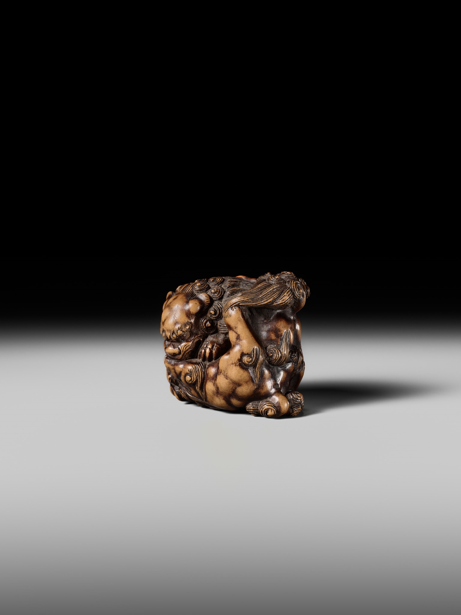 Artwork by Tomoyuki Tanaka, A LARGE AND POWERFUL WOOD NETSUKE OF TWO SHISHI, Made of Wood